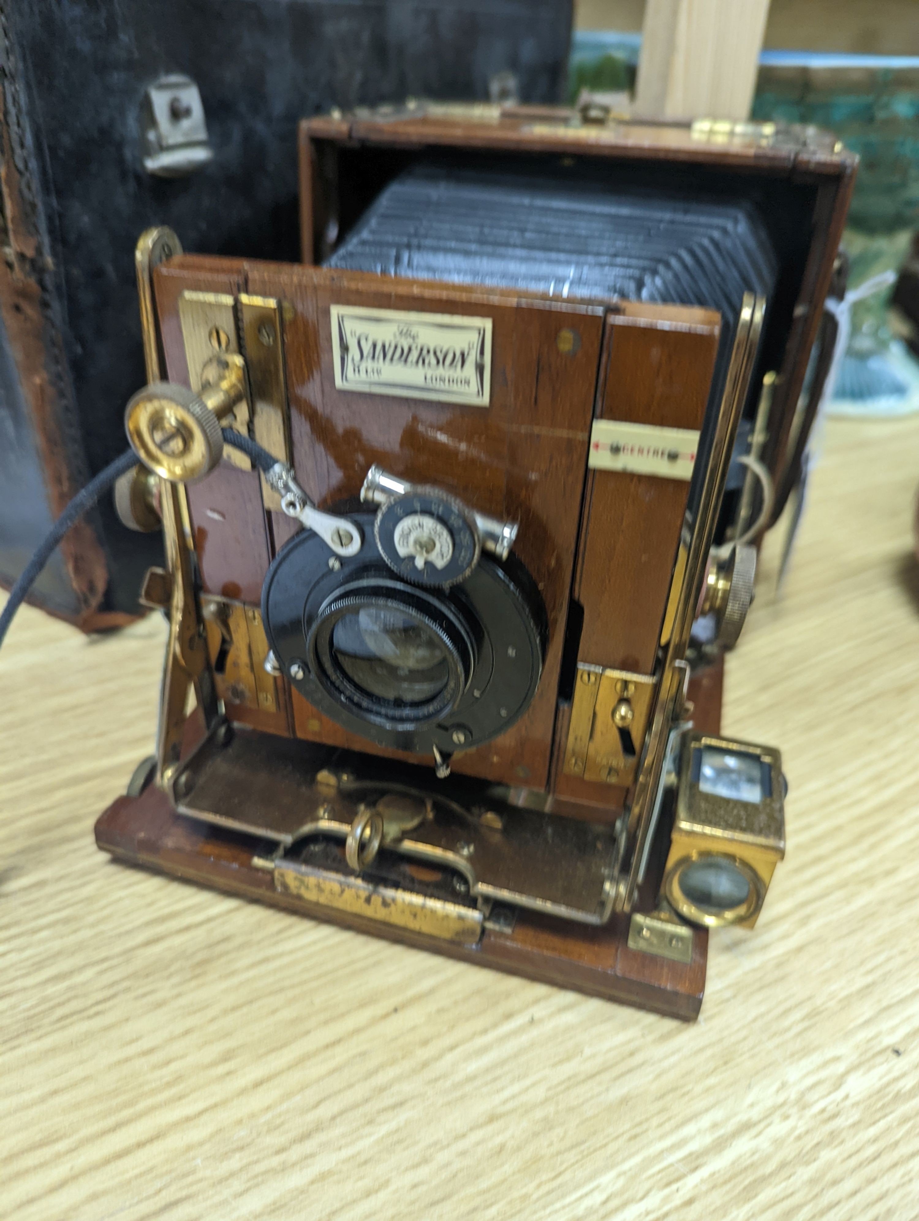 A Sanderson ‘Tropical Model’ plate camera, leather cased with various mahogany plate holders.